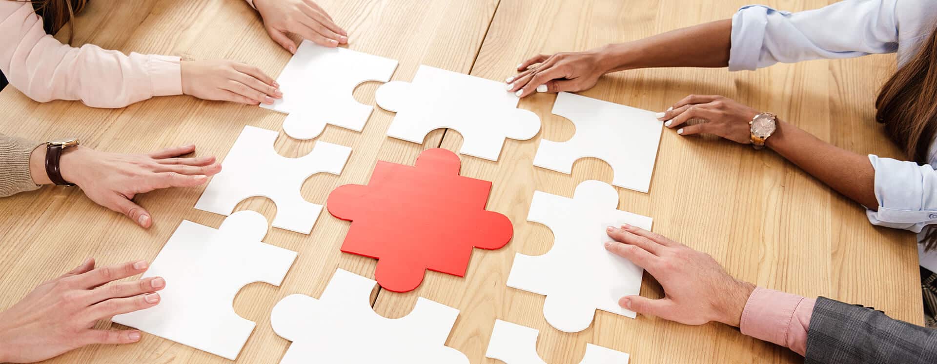 Recovering addicts putting puzzle together as a group