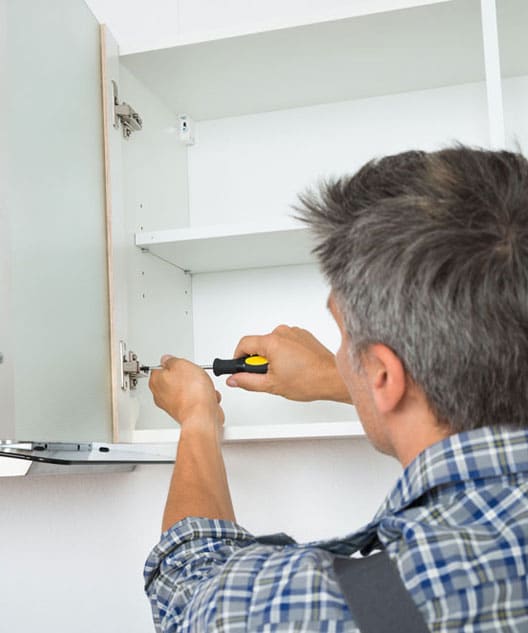 Maintenance worker fixing cabinet