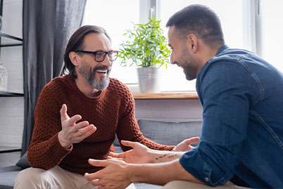 Two men smiling during individual counseling at the drug and alcohol outpatient rehab center in Phoenix, AZ