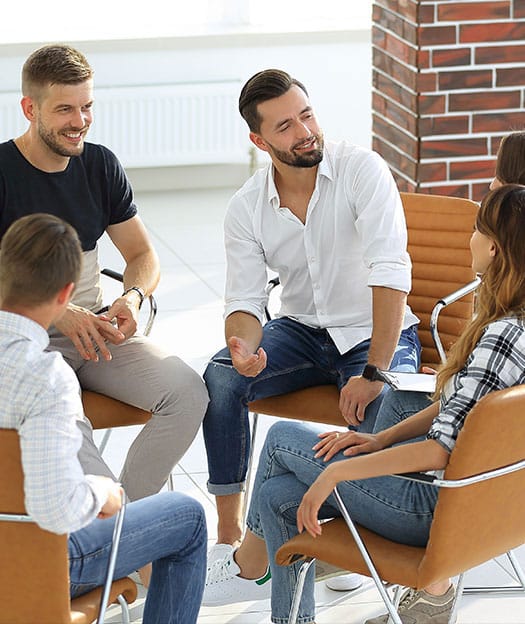Smiling patients in group therapy at The River Source