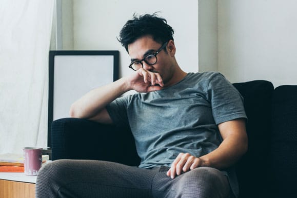 Man thinking about addiction recovery at The River Source