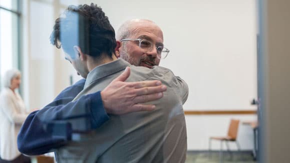 Family members hugging during family therapy