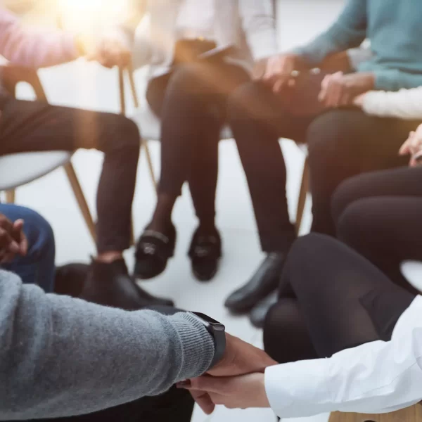 closeup-business-team-sitting-holding-hands closeup-business-team-sitting-holding-hands